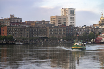 Fototapeta na wymiar An Empty Ferry Boat Moves on Schedule Crossing the River in Savannah Georgia