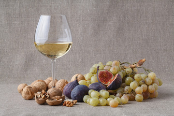 Glass of cold white wine with fruits