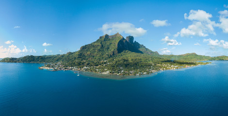 Panoramic aerial view of Vaitape, blue lagoon, white sandy beach and Otemanu mountain at Bora Bora island, Tahiti, French Polynesia (Bora Bora Aerial) - obrazy, fototapety, plakaty