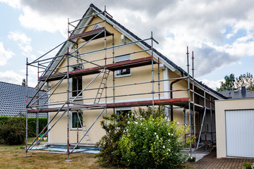 Single-family house with scaffolding - 223518139