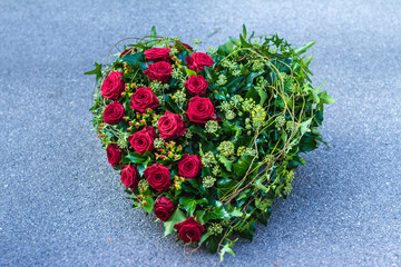 Funeral wreath - ikebana in a shape of the heart isolated on a white background