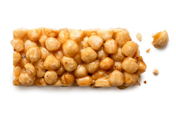 Broken hazelnut snack bar isolated on white from above.