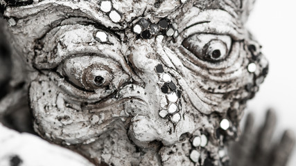 Closeup detail of metamorphic horror screaming face.  White Temple, Thailand