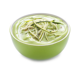 Bowl with delicious zucchini soup on white background