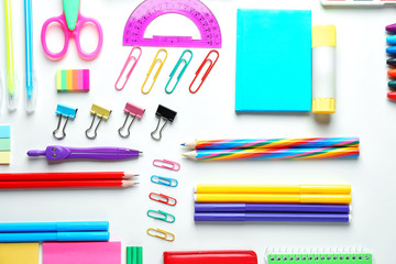 Composition with different school stationery on white background