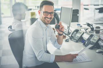 Fototapeta premium Caucasian business man having conversation on Landline phone.