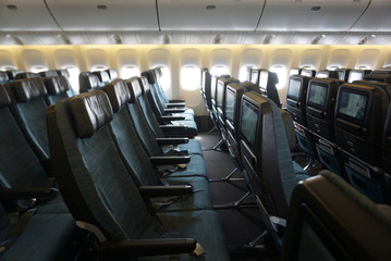 Empty plane cabin seat with green uphostery