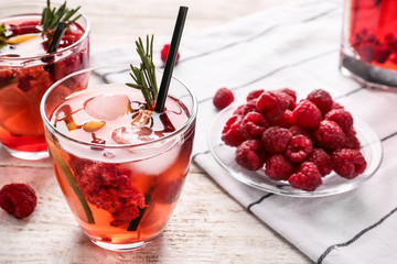 Glasses of fresh raspberry lemonade on wooden table