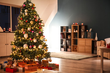 Beautiful decorated Christmas tree in cozy living room