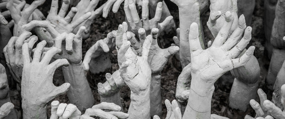 Sculpture of hundreds outreaching hands.  White Temple, Chiang Rai Thailand - obrazy, fototapety, plakaty