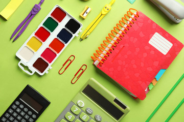 Composition with different school stationery on color background