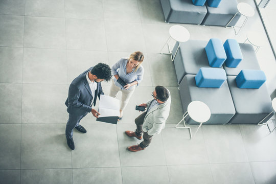 Business People Standing In Business Building. Copy Space.