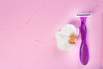 Safety razor with flower on color background