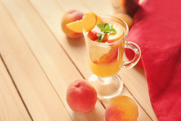 Fresh summer cocktail in glass cup on wooden table