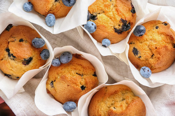 Tasty blueberry muffins on napkin