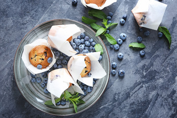 Tray with tasty blueberry muffins on grey table