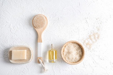 Bath products with brush on white textured background