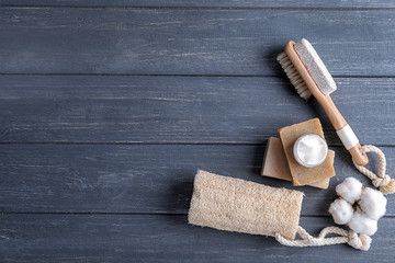 Bath products with loofah and brush on dark wooden table