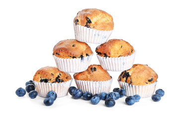 Tasty blueberry muffins on white background