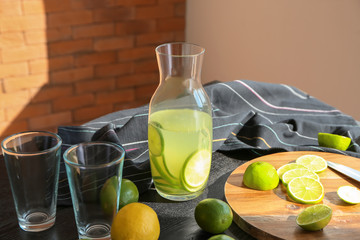 Jug of fresh lime lemonade on table