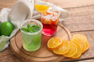 Fresh summer cocktails in glasses on wooden board