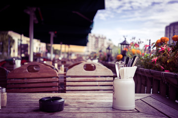 Table of a street cafe in a European city. Toned photo