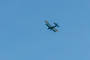 Biplane flying in blue sky