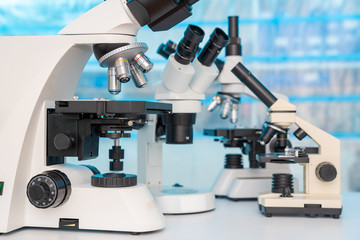 Four microscopes of different designs in the laboratory