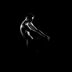 Black and white silhouette of male ballet dancer.