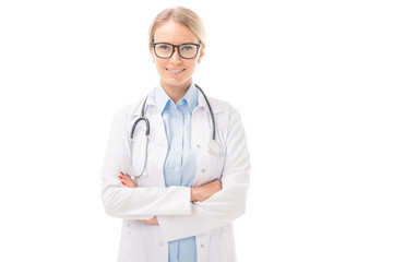 Fototapeta premium confident young female doctor with crossed arms looking at cameraisolated on white