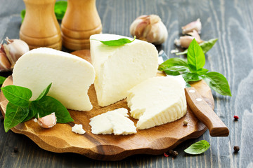 cheese brynza  and garlic on a cutting board.