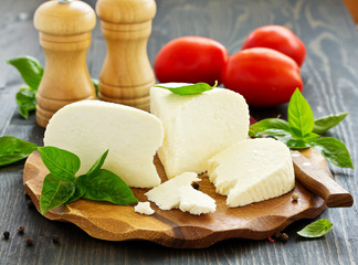 cheese brynza  and garlic on a cutting board.