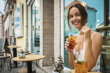 young brunette woman having ice tea