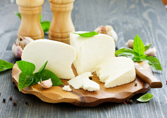 cheese brynza  and garlic on a cutting board.