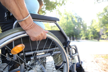 Senior woman in wheelchair outdoors, closeup