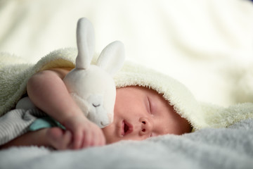 Newborn baby boy portrait on white carpet closeup. Motherhood and new life concept