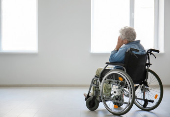 Lonely senior woman in wheelchair indoors - Powered by Adobe