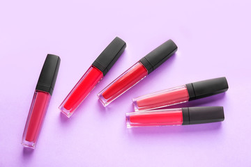 Different liquid lipsticks on color background