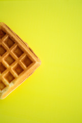 Belgian waffles on yellow background