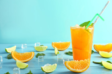 Fresh summer cocktail in glass on color wooden table