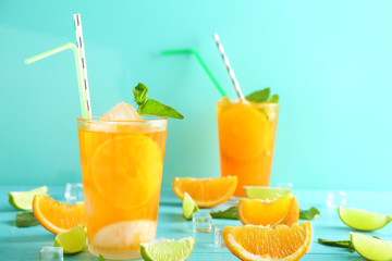 Fresh summer cocktail in glass on color wooden table