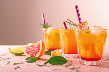 Fresh summer cocktail in glasses on color table