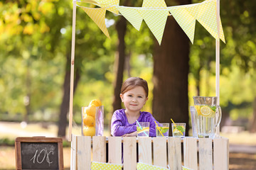 Little girl at lemonade stand in park