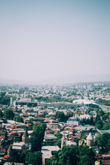 Perspective view of Old Tbilisi, the capital of Georgia. Hot sunny afternoon. Red rooftops of old houses. Vintage colors
