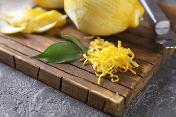 Fresh lemon zest on wooden board