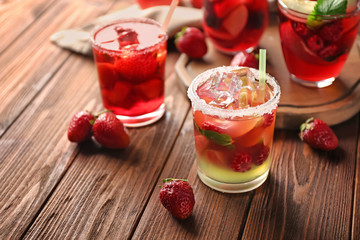 Fresh summer cocktails in glasses on wooden table