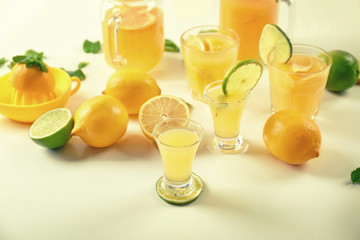 Glasses of fresh lemon juice on light table