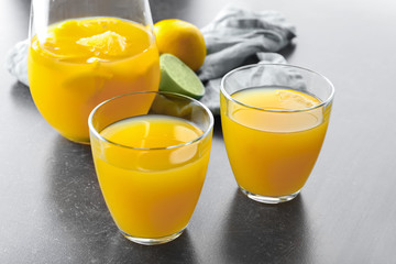Glassware of fresh lemon juice on dark table