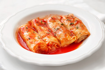 Stuffed cabbage leaves in tomato sauce on plate