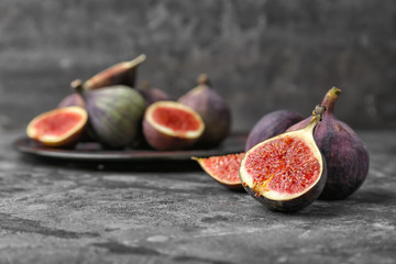 Fresh ripe figs on grey table